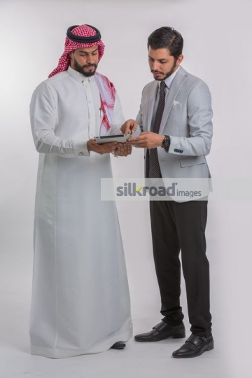 Businessmen standing using the device|