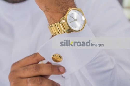 Man fixing cufflinks